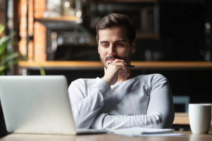Man reading fiction on his laptop