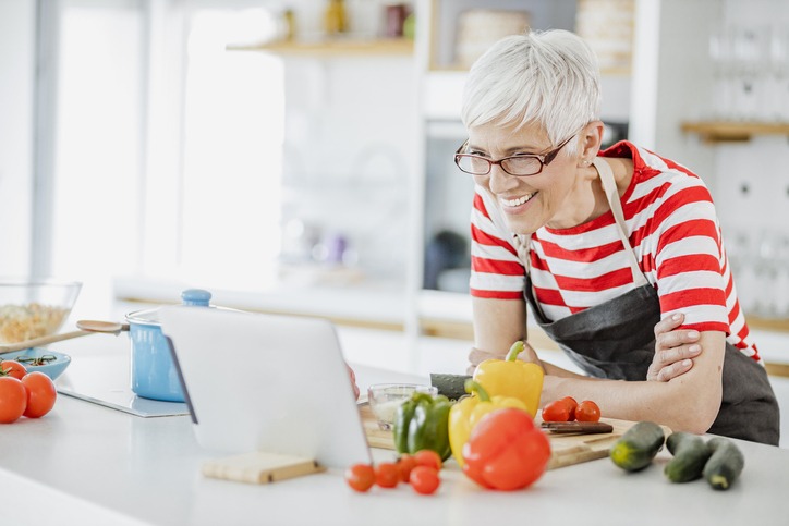 Senior woman taking an online cooking class