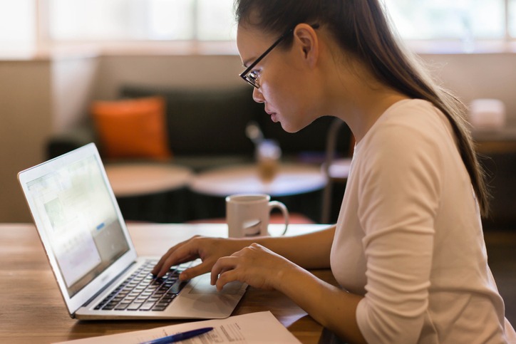 Woman choosing an option online on her laptop