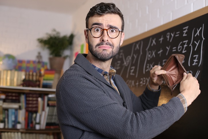 Male teacher with a panicked look on his face, showing his empty wallet
