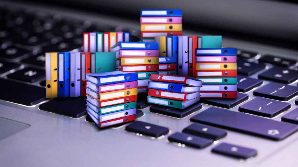 Digital Archive. Laptop Keyboard with Many Downsized Folders, Closeup
