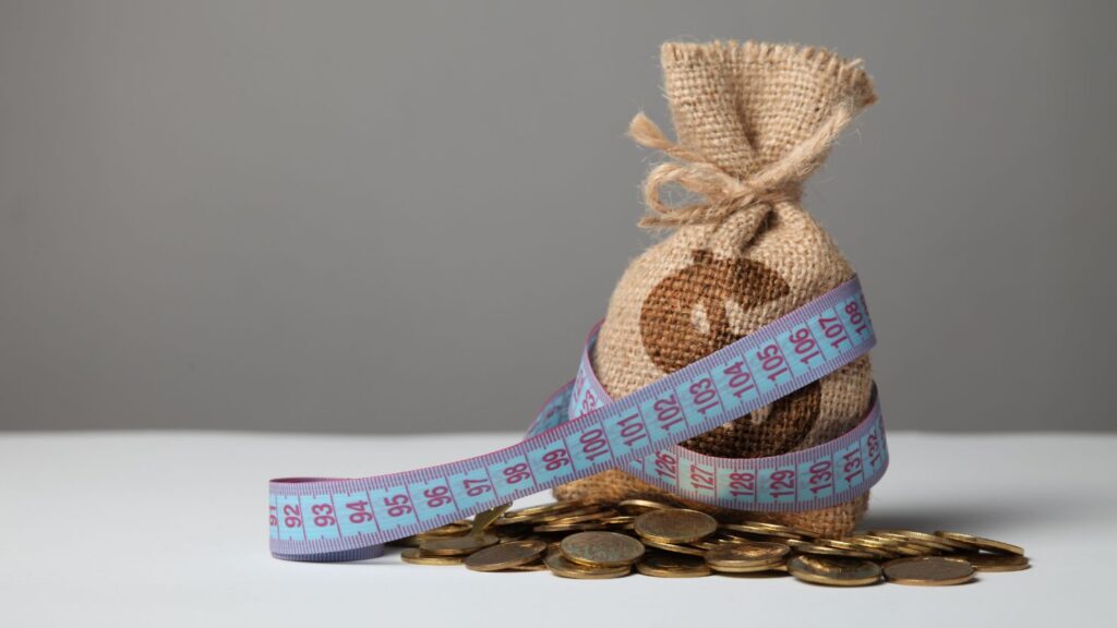 bag with money, measuring tape, and gold coins