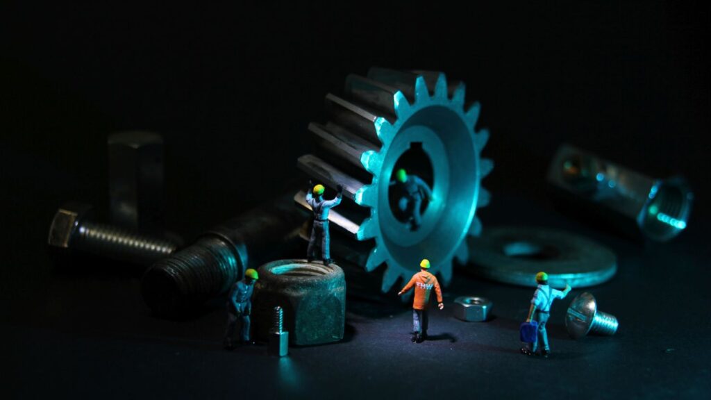 Tiny Mechanic Figures Next To Tools