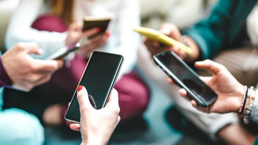 A closeup of smartphones in people's hands
